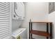 Convenient in-unit laundry featuring a stackable washer and dryer, plus shelving at 235 Mccauley St # D, Chapel Hill, NC 27516