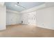 Open living area featuring a light blue ceiling, beige carpet, and connecting rooms create a spacious and versatile floor plan at 235 Mccauley St # D, Chapel Hill, NC 27516