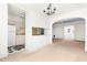 Open living room view showcasing a kitchen, chandelier, archway and light-filled space at 235 Mccauley St # D, Chapel Hill, NC 27516