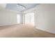 Spacious living room with neutral carpeting, white walls, light blue ceiling, and ample natural light offers a versatile living space at 235 Mccauley St # D, Chapel Hill, NC 27516