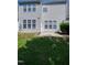 Exterior view of backyard, showing lawn and a small patio at 238 Royal Tower Way, Cary, NC 27513