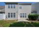 Exterior rear view of home and backyard featuring a small patio and lawn at 238 Royal Tower Way, Cary, NC 27513