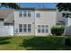 A view of the home's rear exterior showing the backyard and siding with plenty of windows at 238 Royal Tower Way, Cary, NC 27513