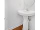 Pedestal sink and round mirror in a brightly lit bathroom at 238 Royal Tower Way, Cary, NC 27513