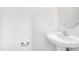 Pedestal sink and round mirror in a brightly lit bathroom at 238 Royal Tower Way, Cary, NC 27513