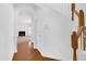 Bright foyer featuring wood floors, an arched entryway, and a staircase leading to the upper level at 238 Royal Tower Way, Cary, NC 27513