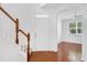 Warm and inviting foyer with wood floors, staircase, and an open view to a bright living space at 238 Royal Tower Way, Cary, NC 27513