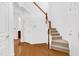 Inviting foyer with gleaming hardwood floors, a staircase with wood railings, and an open layout at 238 Royal Tower Way, Cary, NC 27513