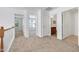 Upstairs hallway with multiple rooms and neutral colors at 238 Royal Tower Way, Cary, NC 27513