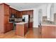 Well-equipped kitchen features stainless steel appliances, a central island, and wooden cabinetry for a warm feel at 238 Royal Tower Way, Cary, NC 27513