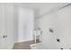 Functional laundry room with a utility sink and overhead shelving for storage at 238 Royal Tower Way, Cary, NC 27513