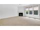 Spacious living room featuring a cozy fireplace and large windows, perfect for relaxation and natural light at 238 Royal Tower Way, Cary, NC 27513
