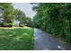 Picturesque walking trail surrounded by lush greenery, offering a peaceful retreat for exercise and nature enthusiasts at 238 Royal Tower Way, Cary, NC 27513