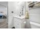 Bathroom featuring white cabinetry, modern fixtures, and a view of the dining room at 2603 Stafford Ave # Apt C, Raleigh, NC 27607