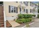 Charming yellow townhouse featuring well-maintained landscaping and a welcoming front porch at 2603 Stafford Ave # Apt C, Raleigh, NC 27607