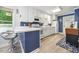 Well-lit kitchen featuring white cabinets, breakfast bar, and an open layout for easy access at 2603 Stafford Ave # Apt C, Raleigh, NC 27607