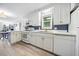 Bright kitchen with white cabinetry, modern appliances, and a seamless flow into living area at 2603 Stafford Ave # Apt C, Raleigh, NC 27607