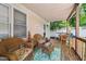 Relaxing covered porch featuring wicker furniture and a view of the yard at 2603 Stafford Ave # Apt C, Raleigh, NC 27607