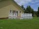 Exterior shot of backyard showing a white patio with lattice detailing and lawn at 2817 Buckboard Ln, Raleigh, NC 27603