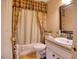 Cozy bathroom features a floral curtained shower and vanity with a sink and traditional fixtures at 2817 Buckboard Ln, Raleigh, NC 27603
