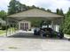 Spacious carport with a shed, along with stored lawn equipment and tools at 2817 Buckboard Ln, Raleigh, NC 27603