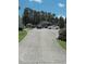 Long concrete driveway leading to carport, cars, and gazebo at 2817 Buckboard Ln, Raleigh, NC 27603