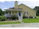 Side exterior showcasing a well-maintained yard and a covered porch with stairs leading to the entrance at 2817 Buckboard Ln, Raleigh, NC 27603