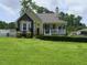 Inviting two-story home featuring a charming front porch, well-manicured lawn, and mature trees at 2817 Buckboard Ln, Raleigh, NC 27603