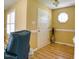 Inviting foyer with a white door, warm lighting, hardwood floors, and an octagonal accent window at 2817 Buckboard Ln, Raleigh, NC 27603