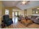 Inviting living room featuring hardwood floors, comfortable seating, and views into other living spaces at 2817 Buckboard Ln, Raleigh, NC 27603