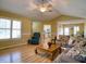 Bright living room with hardwood floors, large windows, and comfortable seating, perfect for relaxation at 2817 Buckboard Ln, Raleigh, NC 27603