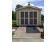 Yellow shed with white trim and double doors providing exterior storage at 2817 Buckboard Ln, Raleigh, NC 27603