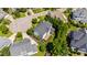 Aerial view of a house with a private deck, landscaping, and a driveway with easy street access at 307 Beacon Falls Ct, Cary, NC 27519