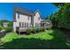 The backyard with a deck, patio and lush green lawn is perfect for outdoor activities and relaxation at 307 Beacon Falls Ct, Cary, NC 27519