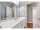 A view of a bathroom with blue walls, white cabinets and marble countertop at 307 Beacon Falls Ct, Cary, NC 27519