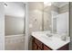 Bathroom vanity with white countertop, wooden cabinets, and large mirror at 307 Beacon Falls Ct, Cary, NC 27519