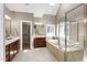 Bright primary bathroom with double vanity, soaking tub, and separate glass shower at 307 Beacon Falls Ct, Cary, NC 27519