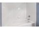 A close-up view of a bright white tiled bathtub and wall with chrome fixtures at 307 Beacon Falls Ct, Cary, NC 27519