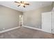 An empty bedroom with carpet, ceiling fan, and doors leading to other rooms at 307 Beacon Falls Ct, Cary, NC 27519