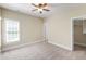 Spacious bedroom with a ceiling fan, a window with blinds, and carpet at 307 Beacon Falls Ct, Cary, NC 27519