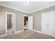 Bedroom featuring neutral paint, two entry doors, and ensuite bathroom access at 307 Beacon Falls Ct, Cary, NC 27519