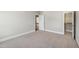 This bedroom has neutral walls and carpeted floors, offering a view of the home's interior at 307 Beacon Falls Ct, Cary, NC 27519