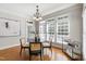 Dining area with hardwood floors, bright windows, chandelier, and views of the yard at 307 Beacon Falls Ct, Cary, NC 27519