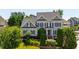 Inviting two-story home featuring well-manicured landscaping and classic architectural details at 307 Beacon Falls Ct, Cary, NC 27519