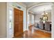 Inviting foyer with hardwood floors, showcasing the front door and the dining room at 307 Beacon Falls Ct, Cary, NC 27519