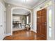 Elegant foyer with gleaming hardwood floors and an open view to a cozy office space at 307 Beacon Falls Ct, Cary, NC 27519