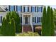 Charming front entrance with brick steps and lush landscaping showcasing curb appeal at 307 Beacon Falls Ct, Cary, NC 27519