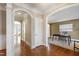 Spacious hallway with hardwood floors, arched openings, and views of multiple rooms at 307 Beacon Falls Ct, Cary, NC 27519