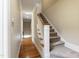 A carpeted staircase in a hallway with hardwood flooring at 307 Beacon Falls Ct, Cary, NC 27519