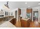 Open kitchen with granite countertops, stainless steel appliances, arched entryways, and breakfast bar at 307 Beacon Falls Ct, Cary, NC 27519